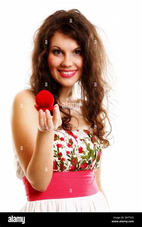 Attractive Young Woman Opens A Present Heart Shaped Red Box And Is Surprised Happy By An