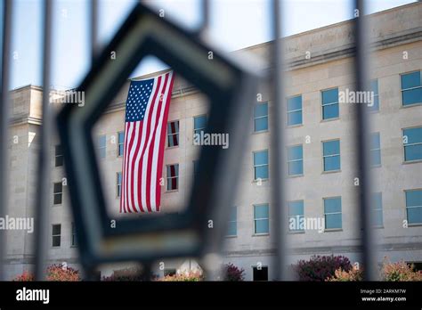 An American Flag Unfurled At Dawn Hangs Over The Pentagon On The
