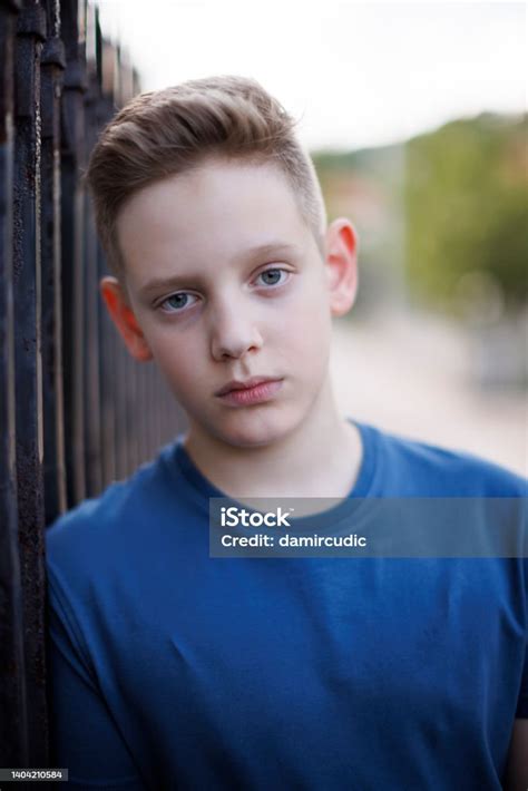 Closeup Portrait Of A Boy With Blue Eyes Seriously Looking At The