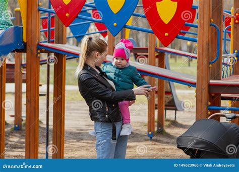 Happy Mom And Daughter Play On The Playground Stock Photo Image Of