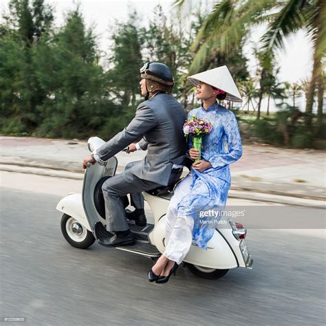 vietnam-young-couple-riding-along-on-classic-vespa-high-res-stock-photo