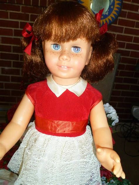 A Close Up Of A Doll Wearing A Dress