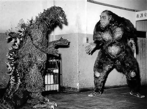 Two Men In Costumes Standing Next To Each Other Near A Tree And Another Man Wearing A Gorilla Suit