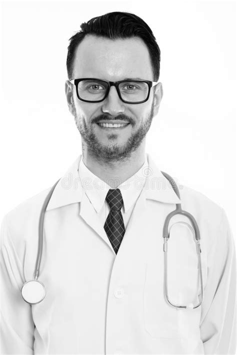 Studio Shot Of Happy Young Man Doctor Smiling While Wearing Eyeglasses