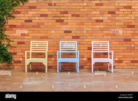 Red Brick Wall With Chairs And Ornamental Stock Photo Alamy