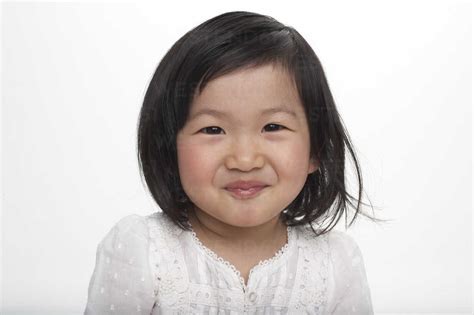 Portrait Of Little Asian Girl Smiling Studio Shot Stock Photo