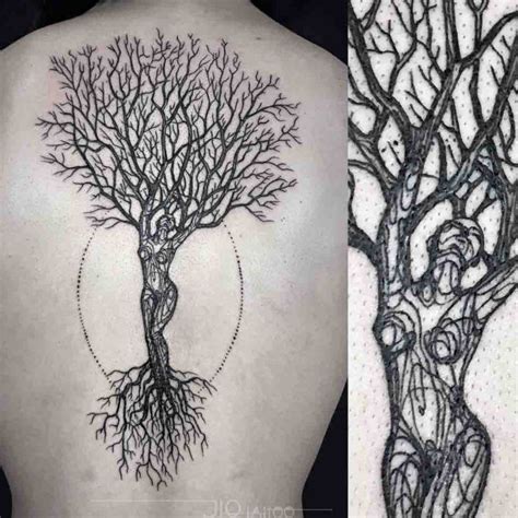 The Back Of A Womans Shoulder With An Intricate Tree Tattoo On It