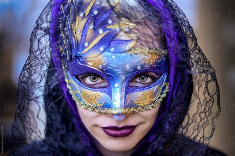 Exotic Beautiful Woman Wearing A Masquerade Mask Looking Straight At