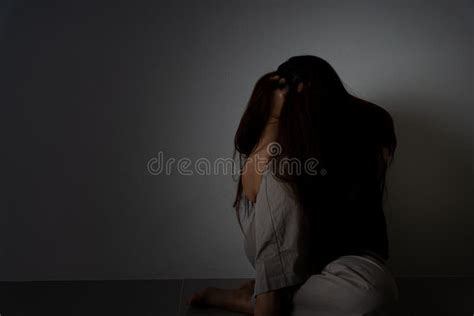 Sad Woman Hug Her Knee And Cry Sitting Alone In A Dark Room Depression
