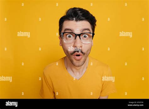 Portrait Of Amazed Foolish Cheerful Caucasian Guy In Glasses And In An