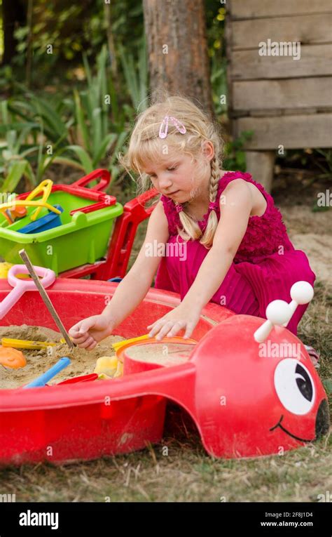 Little Blond Girl Playing In Sandpit Stock Photo Alamy