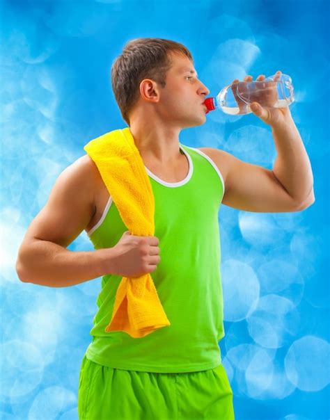 Premium Photo A Young Sports Man Drinking Water