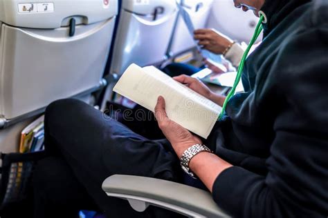 Attendence Passenger Read Book On The Plane Seat Stock Photo Image Of