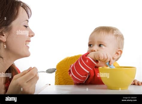 Happy Mother Feeding Her Baby Stock Photo Alamy