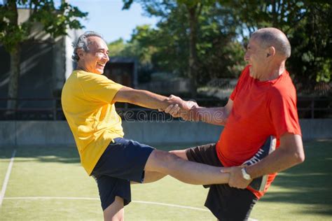 Helpful Senior Men Getting Ready For Match On Sunny Day Stock Image