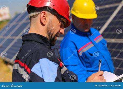 Green Energy, Two Technicians Control Solar Panels Stock Photo - Image