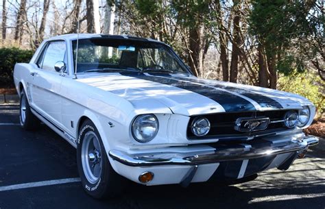 This 1965 Ford Mustang Is Finished In White With Blue Stripes Over A