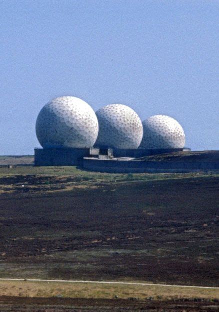 Three Giant Golf Balls Entirely In Scale With The Vast Open Landscape