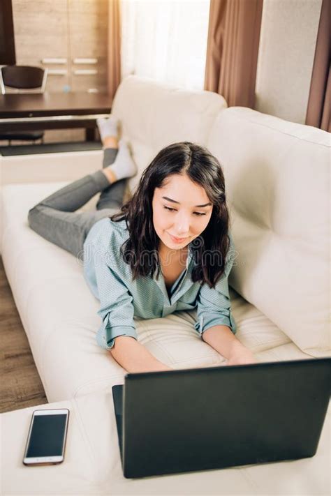 Bbeautiful Woman Using Laptop Computer At Home On Sofa Stock Image
