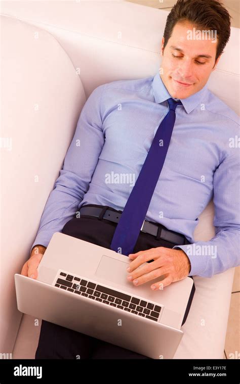 Businessman Lying Couch Using Laptop Stock Photo Alamy