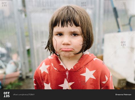 Portrait Of Little Girl Pouting In Greenhouse Stock Photo Offset
