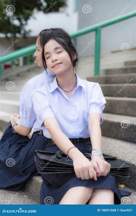 Asian Thai High Schoolgirls Student Couple Leaning And Sleeping Stock