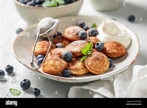 Homemade Poffertjes With Blueberries And Powdered Sugar Stock Photo Alamy