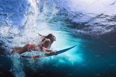Surfer Girl Dive Under Wave In Surfing Wakeboarding Kite Surfing
