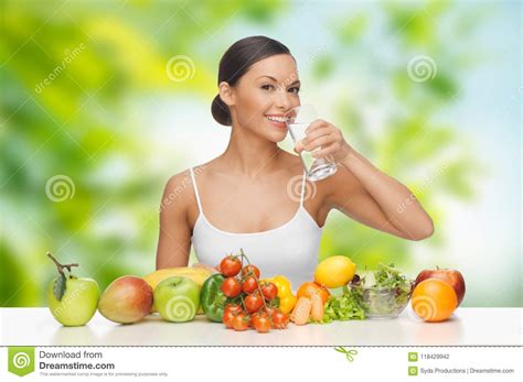 Woman With Healthy Food On Table Drinking Water Stock