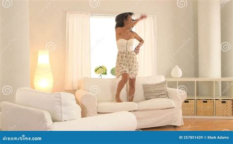 taiwanese woman jumping on couch and dancing in living room stock video video of women person