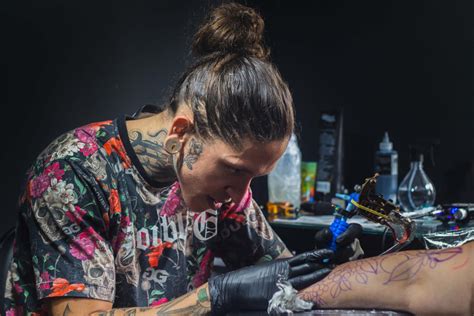 Man Tattooing Person On Arm · Free Stock Photo