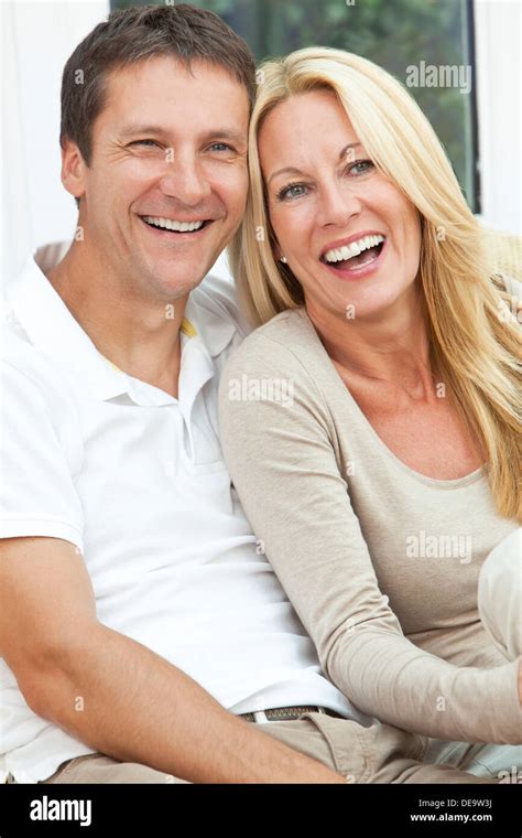 Attractive Successful Happy Middle Aged Man And Woman Couple In Their Forties Sitting Together At