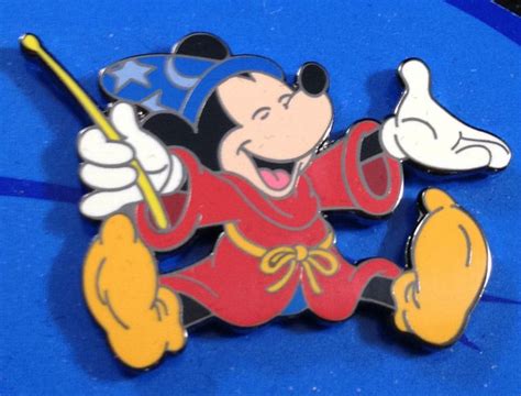A Mickey Mouse Pin Sitting On Top Of A Blue Table