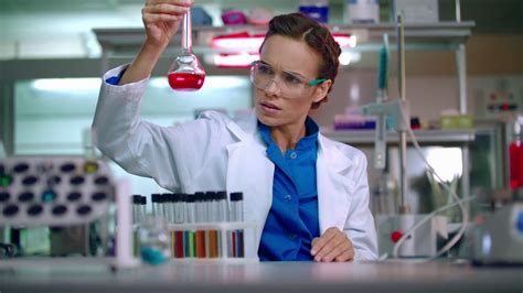 female scientist working at the laboratory scientist cure woman scientist check test tube with