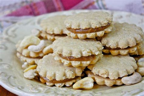 A Plate Full Of Cookies With Peanut Butter And Jelly Fillings On Top