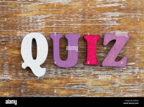 Word Quiz Written With Colorful Letters On Rustic Wooden Surface Stock
