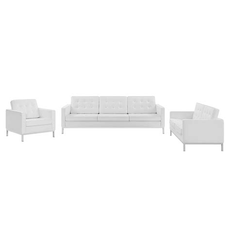 A White Couch And Chair Sitting Next To Each Other On Top Of A White Floor