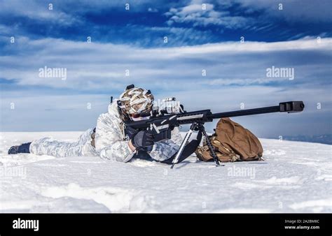 Army Soldier With Sniper Rifle In Action In The Arctic He Lies In The