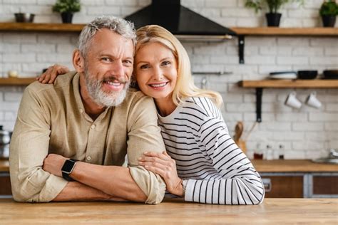 Premium Photo Portrait Of Middle Aged Couple Hugging While Standing Together In Kitchen At Home
