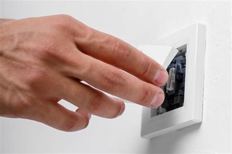 Premium Photo Electrician Installing Light Switch On Wall Close Up