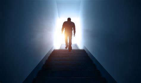 Man Walking Upstairs Into The Light Stock Photo Download Image Now