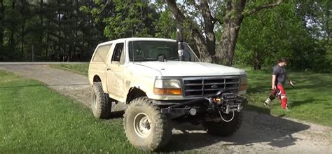 Big Ford Bronco Mud Truck Prepares For Action In The Grass