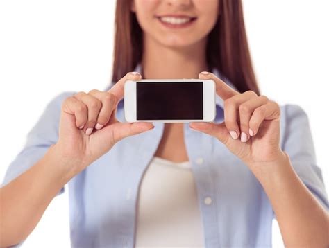 Premium Photo Attractive Young Girl With Gadget On White Wall