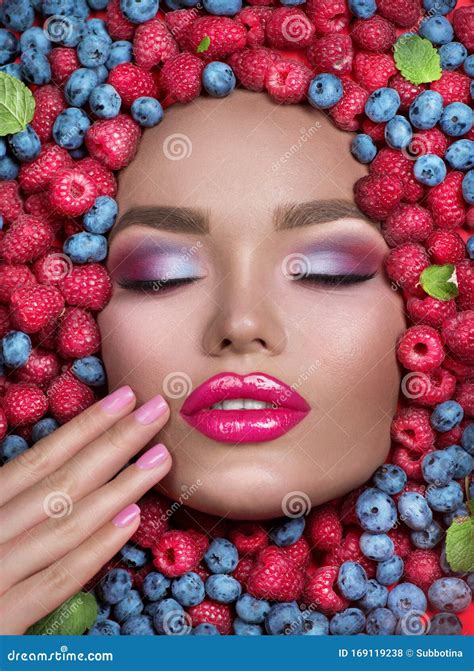 Beauty Fashion Model Girl Lying In Fresh Ripe Fruits Berries And Mint Face In Colorful Berries