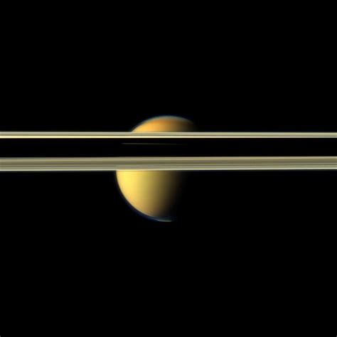 Saturns Rings Obscure Part Of Titans Colorful Visage In This Image