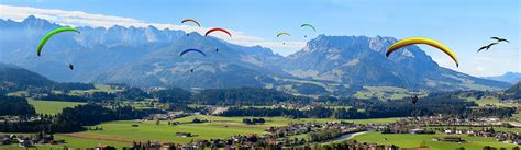 Royalty Free Photo Person Parachuting Down Hillside With Pine Trees