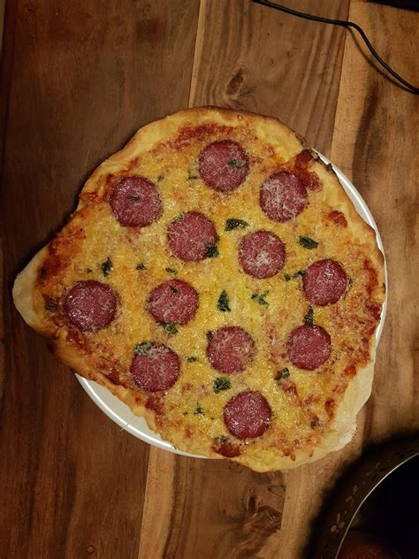Self Made Salami Pizza With Parmesan On Top Made On Pizza Stone