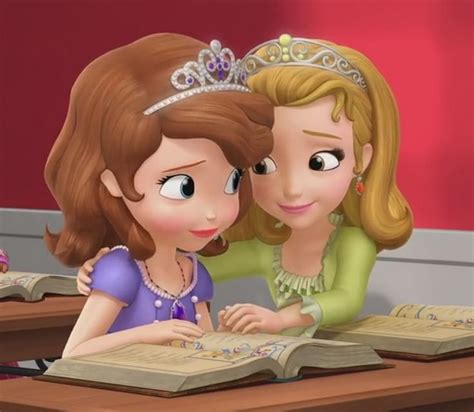 Two Girls Are Sitting At A Desk With Books And Looking At Each Other S Eyes