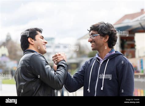 Two Friends Shaking Hands Stock Photo Alamy