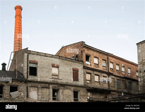 Old Abandoned Industrial Buildings And Tall Chimney Stock Photo Alamy